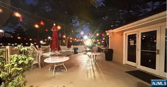 patio at night featuring fence