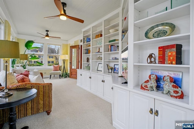 sitting room featuring light carpet and crown molding