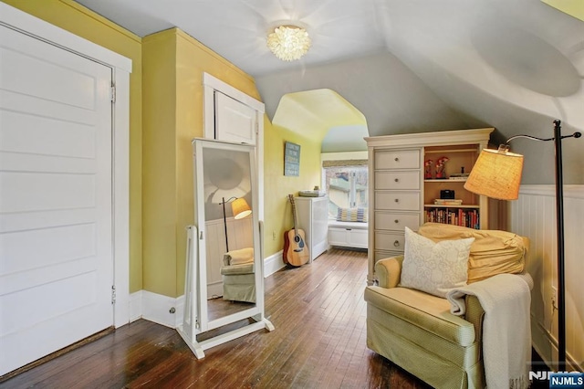 sitting room with dark wood-style floors and vaulted ceiling