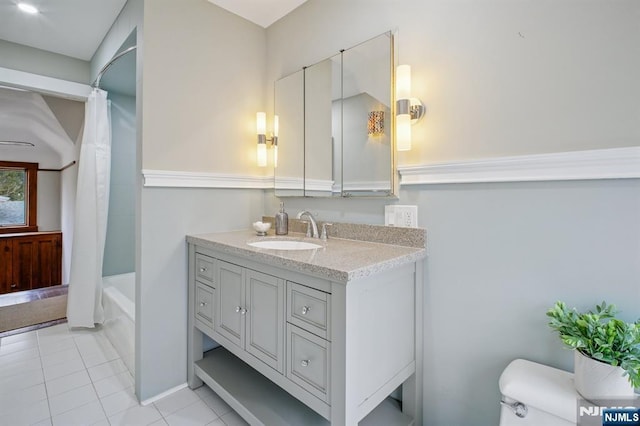 bathroom with toilet, tile patterned floors, shower / tub combo, and vanity