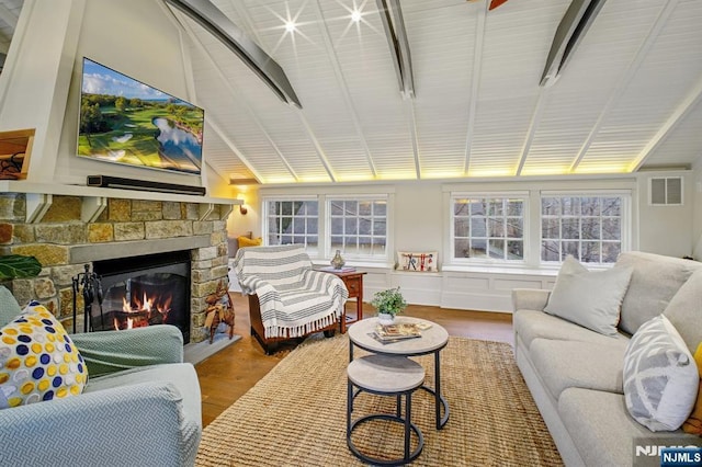 sunroom featuring visible vents and a stone fireplace