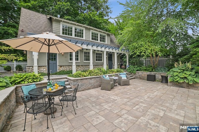 view of patio with fence and outdoor dining area