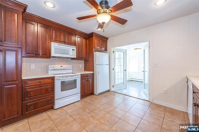 kitchen with decorative backsplash, white appliances, light countertops, and ceiling fan