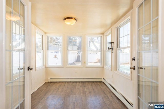 unfurnished sunroom with french doors and a baseboard radiator