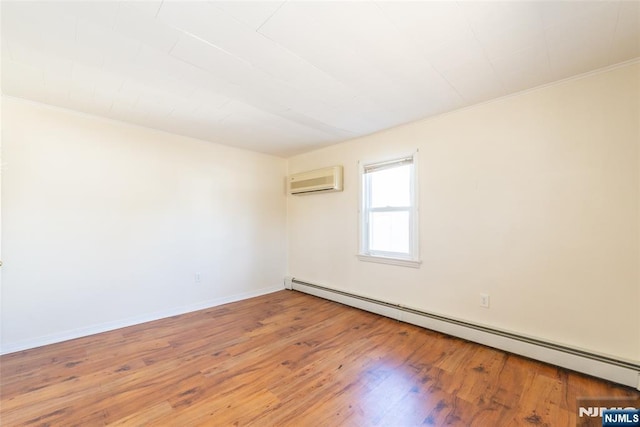 unfurnished room with light wood finished floors, crown molding, baseboards, a wall unit AC, and baseboard heating