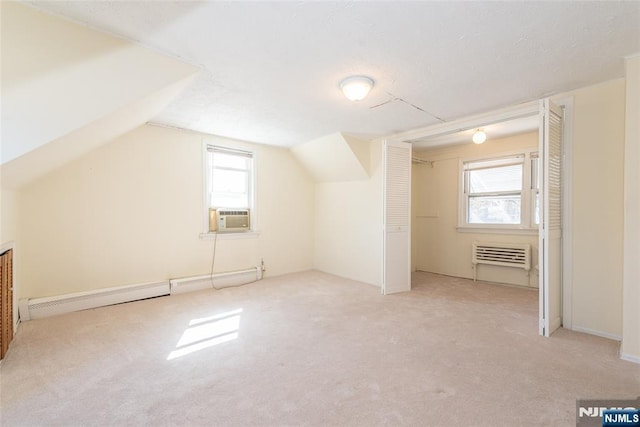 additional living space with lofted ceiling, radiator, carpet floors, and a baseboard radiator