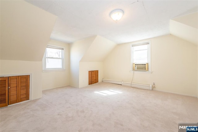 bonus room featuring a baseboard heating unit, carpet floors, cooling unit, and vaulted ceiling