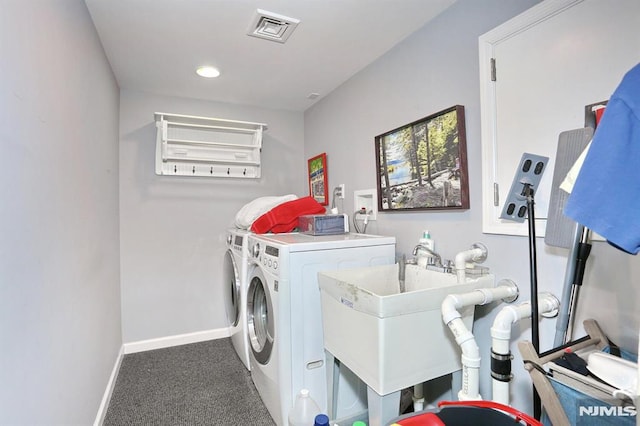 clothes washing area with carpet, visible vents, washer and dryer, laundry area, and baseboards