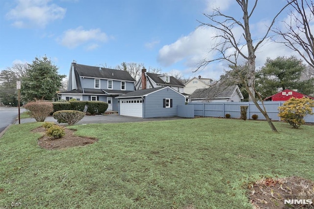 exterior space featuring a garage, driveway, and fence