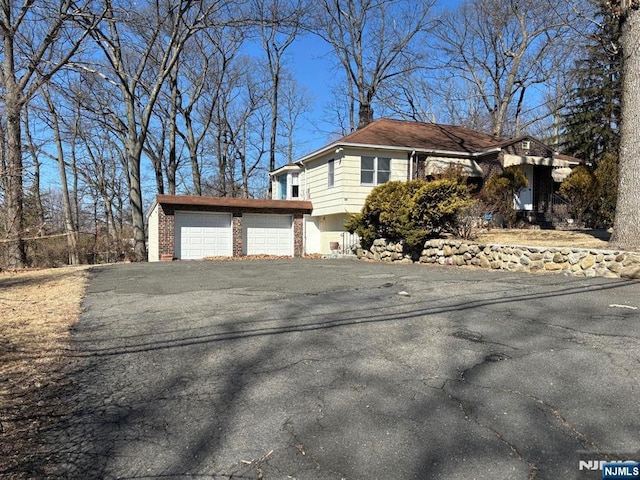 view of home's exterior featuring driveway and an attached garage