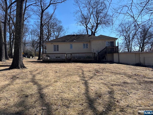 back of property featuring a wooden deck