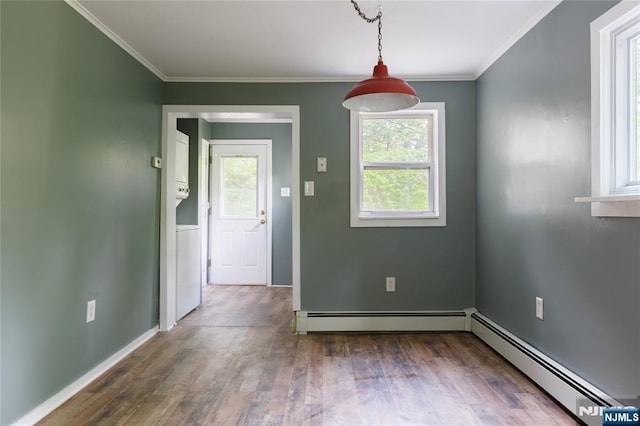 unfurnished dining area featuring a baseboard heating unit, ornamental molding, and wood finished floors