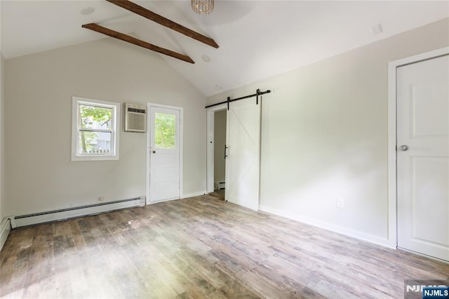 unfurnished room featuring a barn door, wood finished floors, vaulted ceiling with beams, an AC wall unit, and a baseboard heating unit