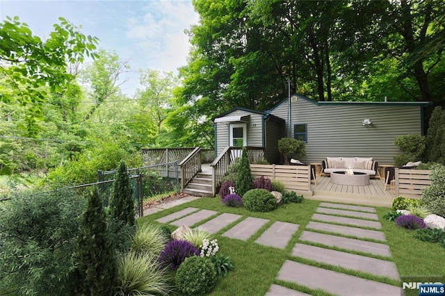 view of yard featuring an outdoor hangout area, fence, and a deck