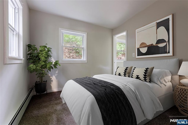 bedroom featuring multiple windows, a baseboard radiator, carpet flooring, and baseboards