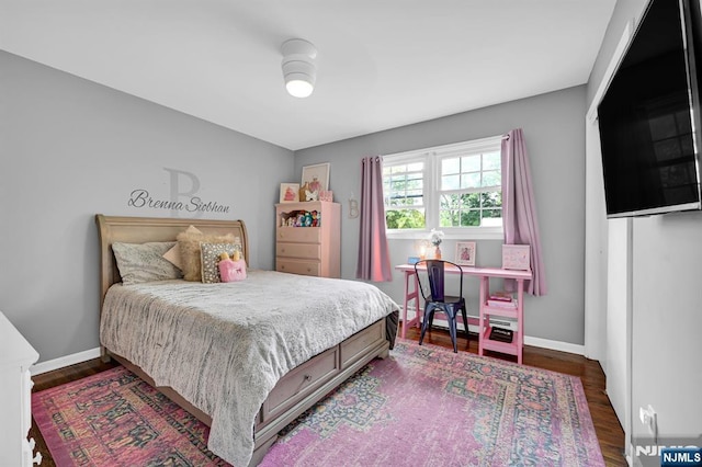 bedroom featuring wood finished floors and baseboards