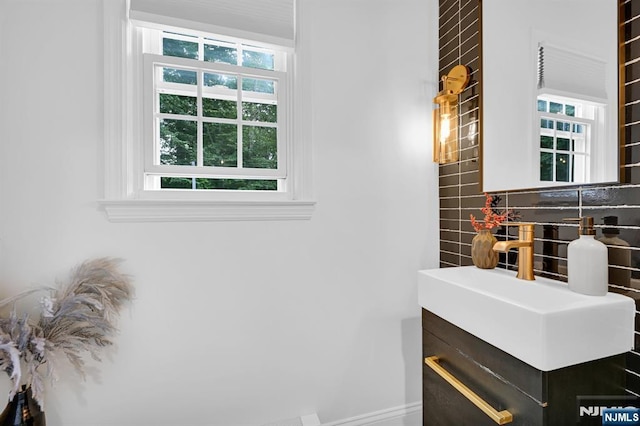 bathroom featuring tasteful backsplash and vanity