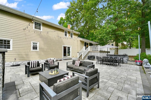 view of patio / terrace featuring outdoor dining space, outdoor lounge area, and fence