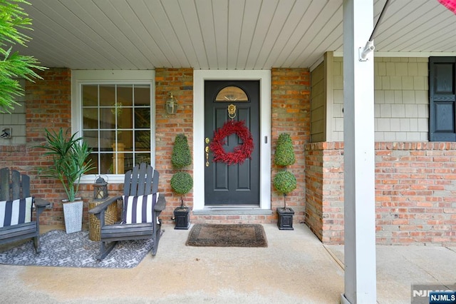 view of exterior entry with brick siding