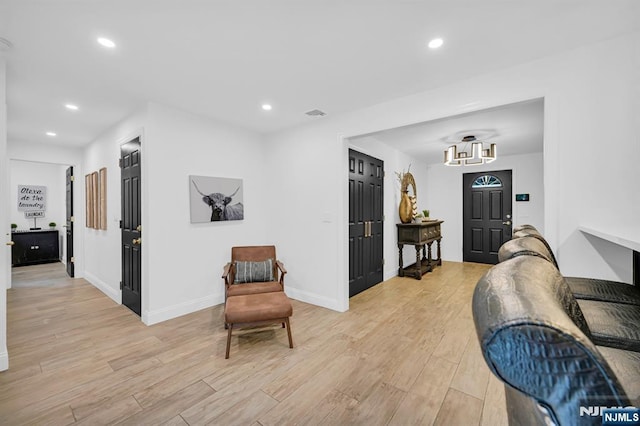 interior space with light wood finished floors, baseboards, and recessed lighting