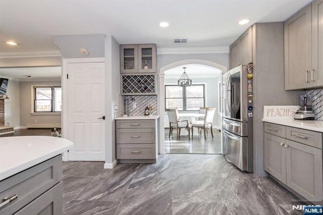 kitchen with visible vents, gray cabinets, tasteful backsplash, smart refrigerator, and crown molding