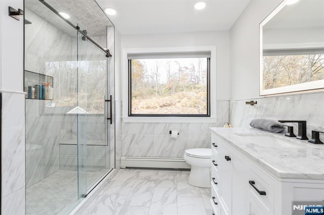 bathroom with a shower stall, marble finish floor, a baseboard radiator, and vanity