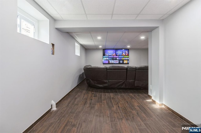 living room featuring a paneled ceiling, dark wood-style floors, baseboards, and recessed lighting