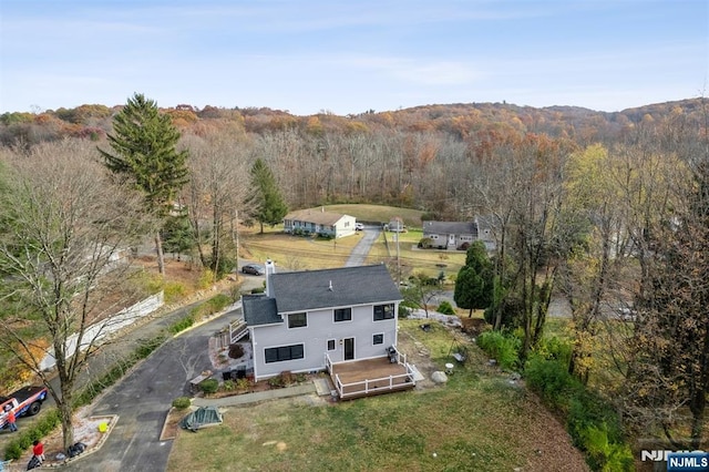 birds eye view of property with a forest view