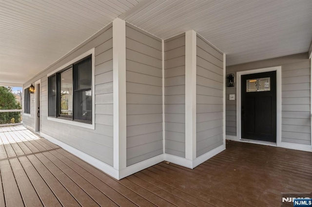 wooden terrace featuring covered porch