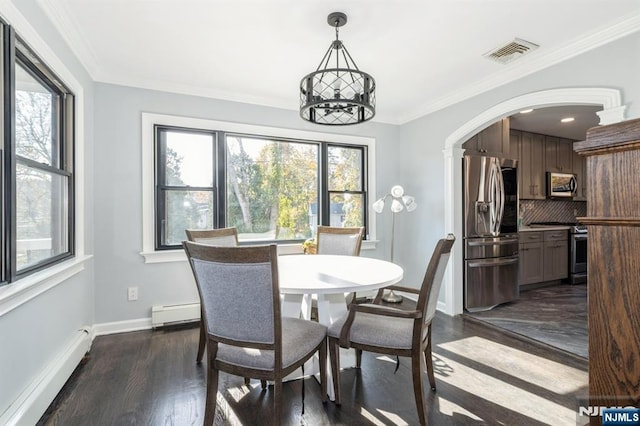 dining area with arched walkways, visible vents, crown molding, and baseboard heating