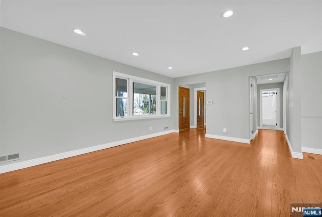 unfurnished living room featuring light wood-style floors, recessed lighting, visible vents, and baseboards