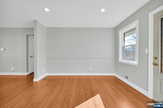 interior space with light wood-style flooring, recessed lighting, visible vents, and baseboards