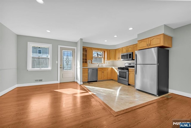 kitchen featuring light wood finished floors, stainless steel appliances, recessed lighting, visible vents, and baseboards