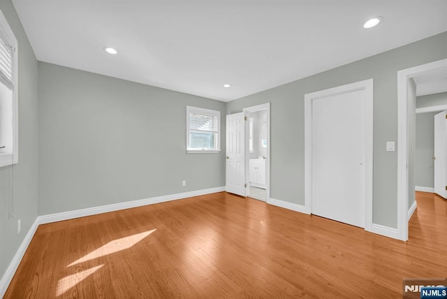 unfurnished bedroom featuring recessed lighting, baseboards, and wood finished floors