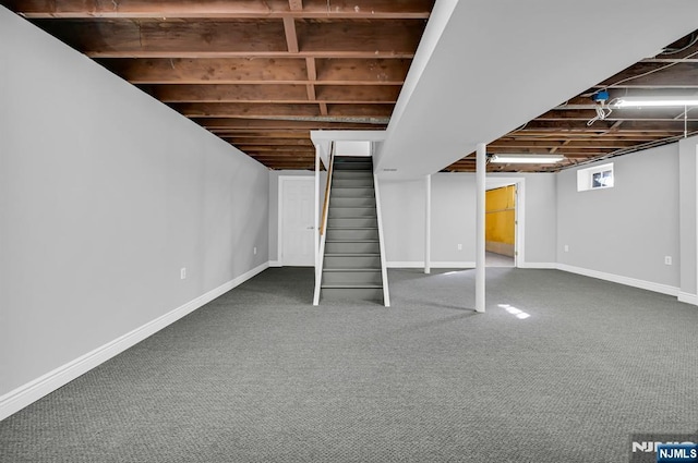 below grade area with carpet floors, stairs, and baseboards