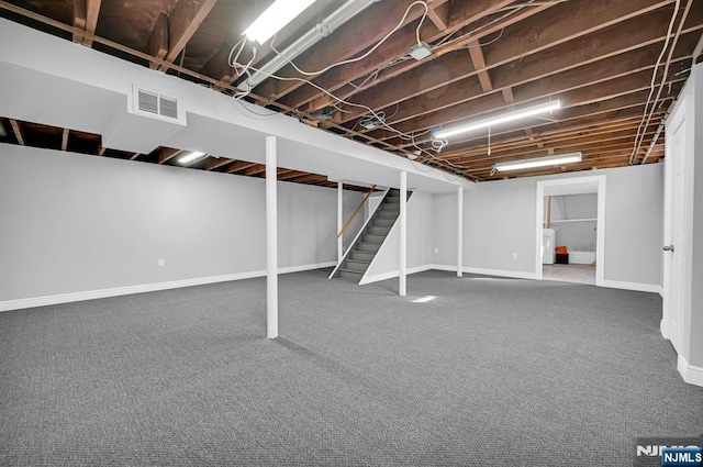 finished basement with carpet floors, stairway, baseboards, and visible vents