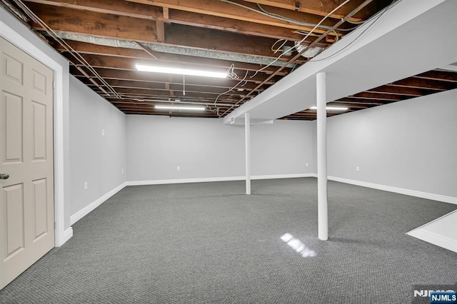 finished basement with baseboards and carpet flooring