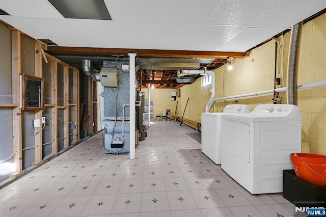 basement featuring washing machine and dryer and tile patterned floors