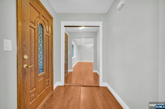 hallway with light wood-style flooring and baseboards