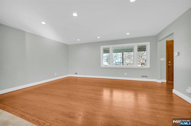 unfurnished room featuring light wood-type flooring, baseboards, and recessed lighting