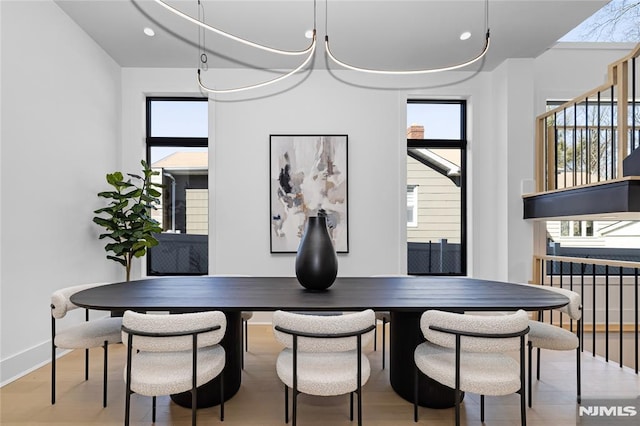 dining space with baseboards, breakfast area, wood finished floors, and recessed lighting