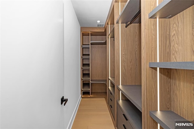 spacious closet featuring visible vents and light wood-style flooring