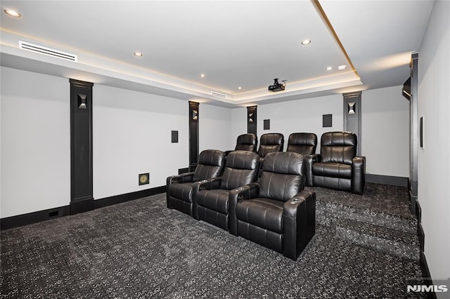 cinema featuring a tray ceiling, visible vents, baseboards, and recessed lighting