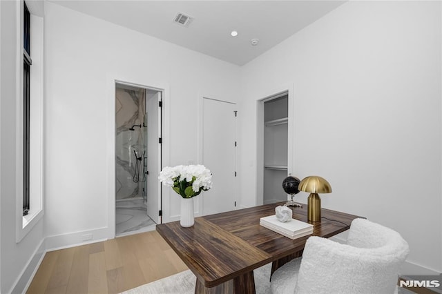 home office featuring baseboards, wood finished floors, visible vents, and recessed lighting