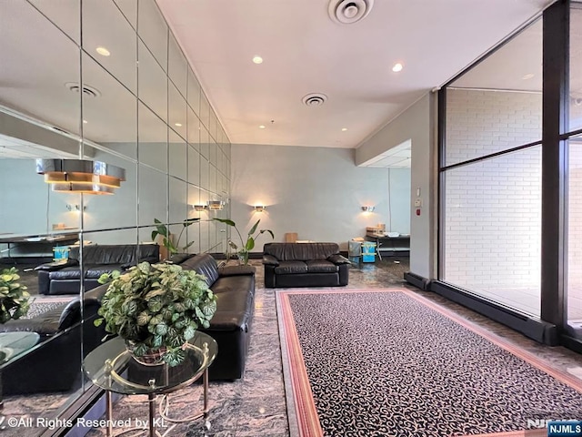 living area with visible vents and recessed lighting