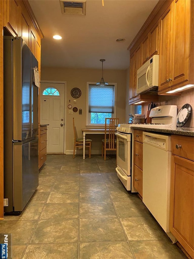 kitchen featuring white appliances, brown cabinets, recessed lighting, decorative light fixtures, and tasteful backsplash