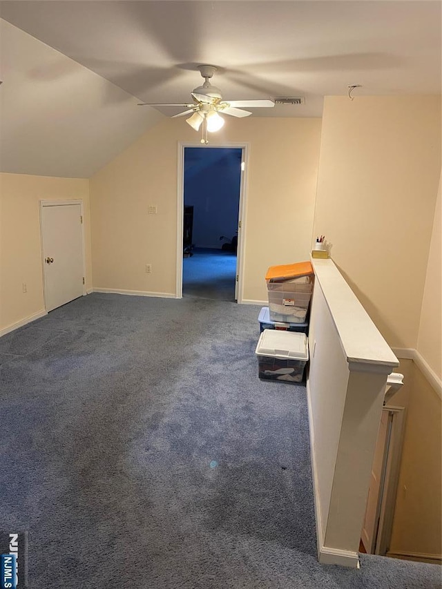additional living space featuring ceiling fan, carpet, lofted ceiling, and baseboards