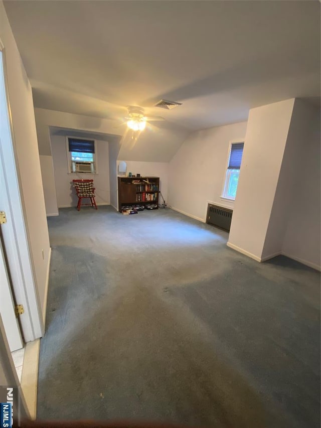 additional living space with carpet, a ceiling fan, vaulted ceiling, cooling unit, and a wall mounted air conditioner