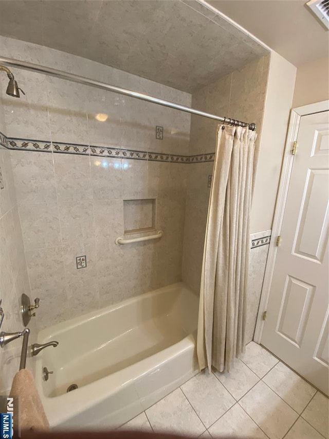 bathroom with tile patterned flooring and shower / bath combo
