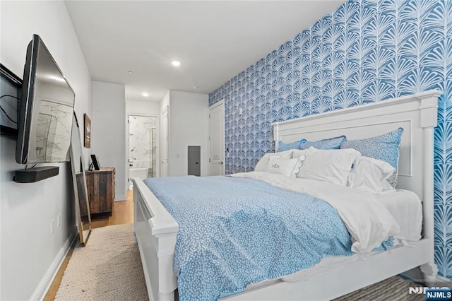 bedroom with recessed lighting, ensuite bathroom, wood finished floors, baseboards, and wallpapered walls